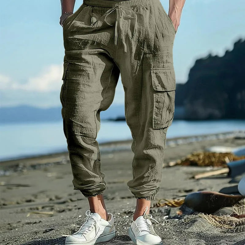 Men's loose linen trousers with ankle tie closure in army green colour.