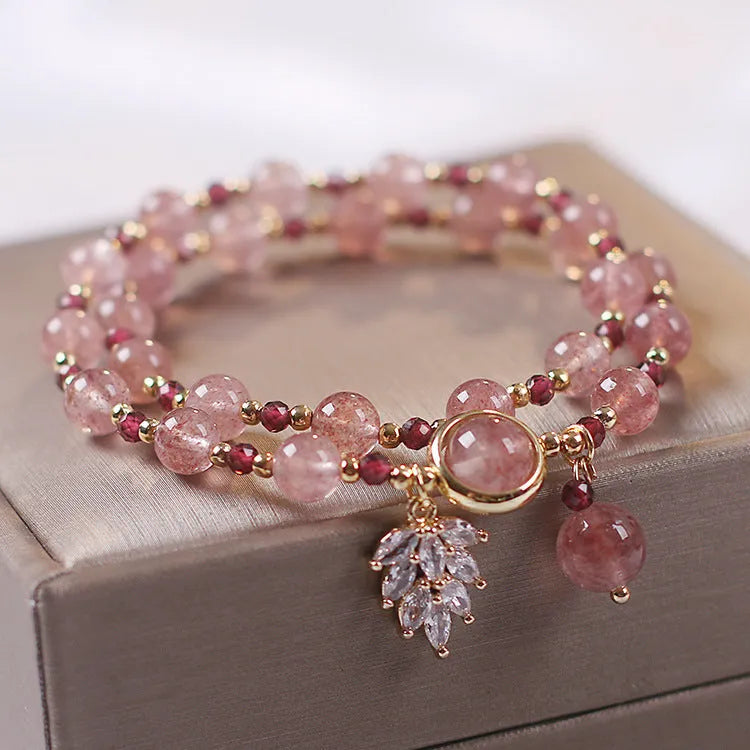 Red double-layer crystal bracelet with Lucky Cat charm and floral beads on wrist