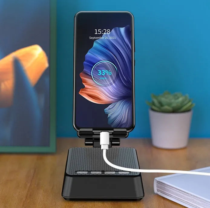Black mobile phone broadcaster stand with integrated Bluetooth speaker and HD microphone on a desk.