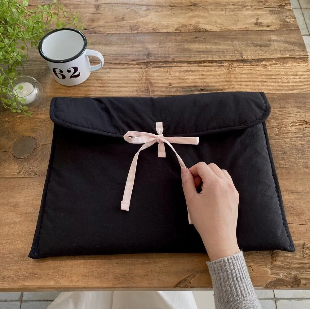 Women's black quilted laptop bag with ballet bow and striped pattern, showing 11-inch and 13-14 inch size options