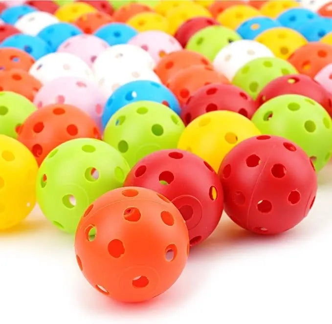 Multi-colour golf practice balls with 26-hole design including red, orange, blue, green, white and yellow