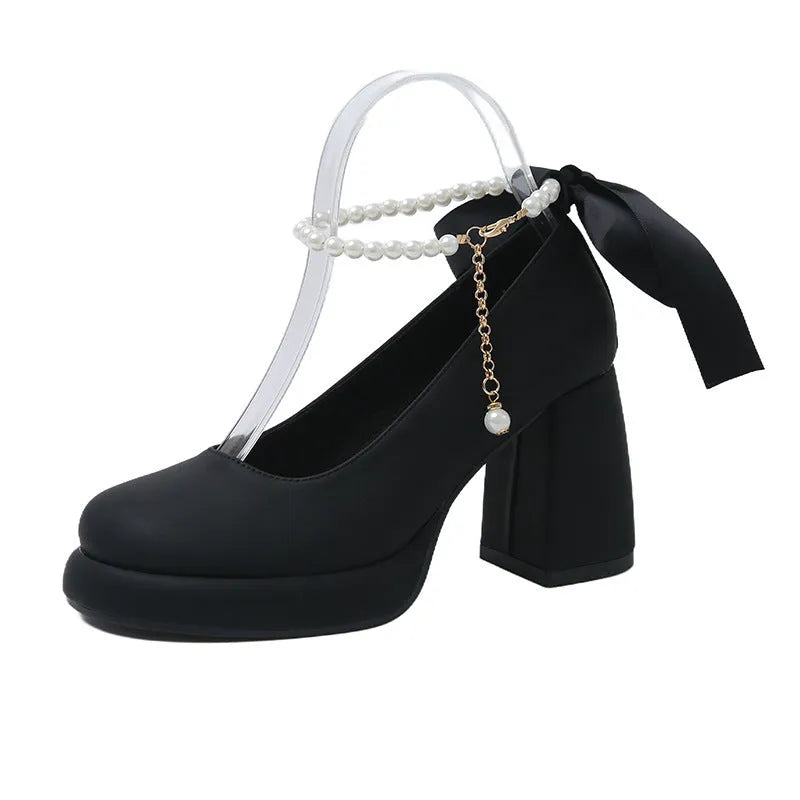 Beige women's Mary Jane shoes with a chunky heel and an ankle-strap buckle on a white background.