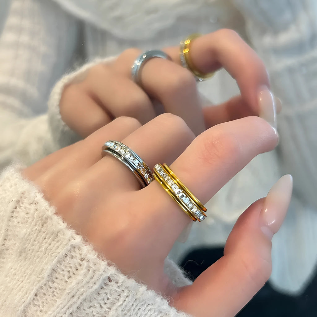 Titanium steel rotatable ring with starry sky design in gold electroplate finish on a dark background