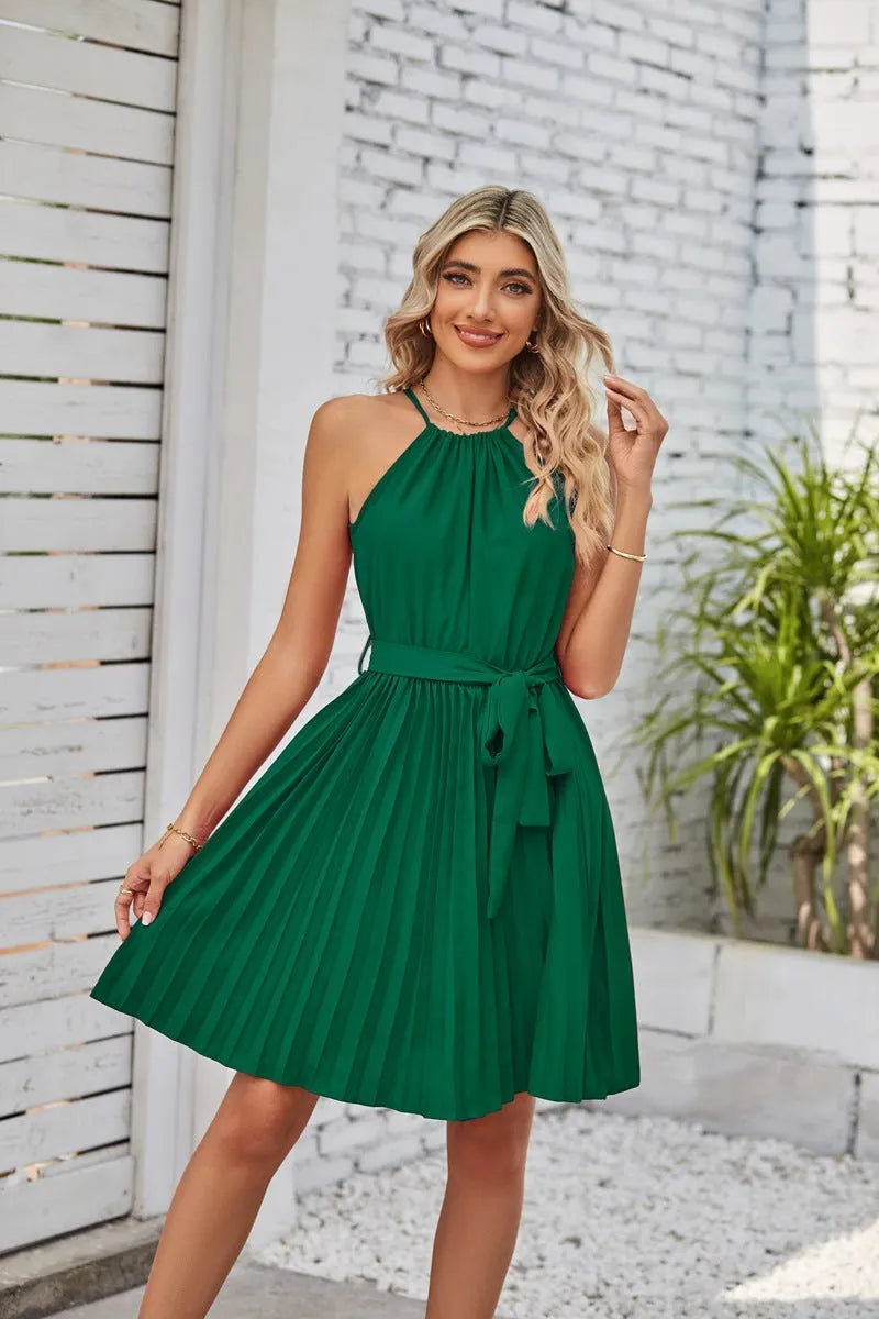 Women's black chiffon halter neck sundress with a pleated skirt and tie belt.
