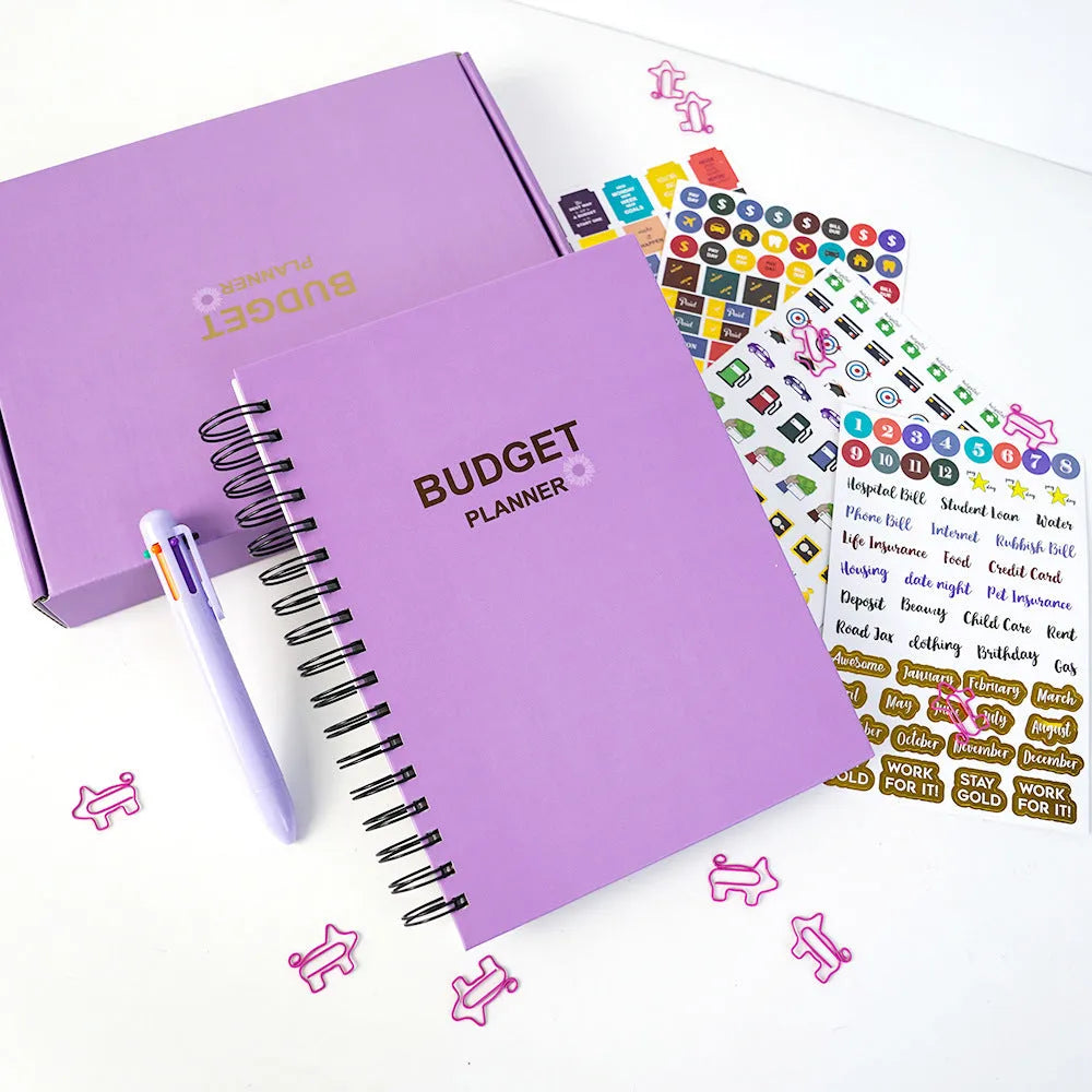 Purple coil-bound budget book set with pen, stickers and paper clips for financial planning