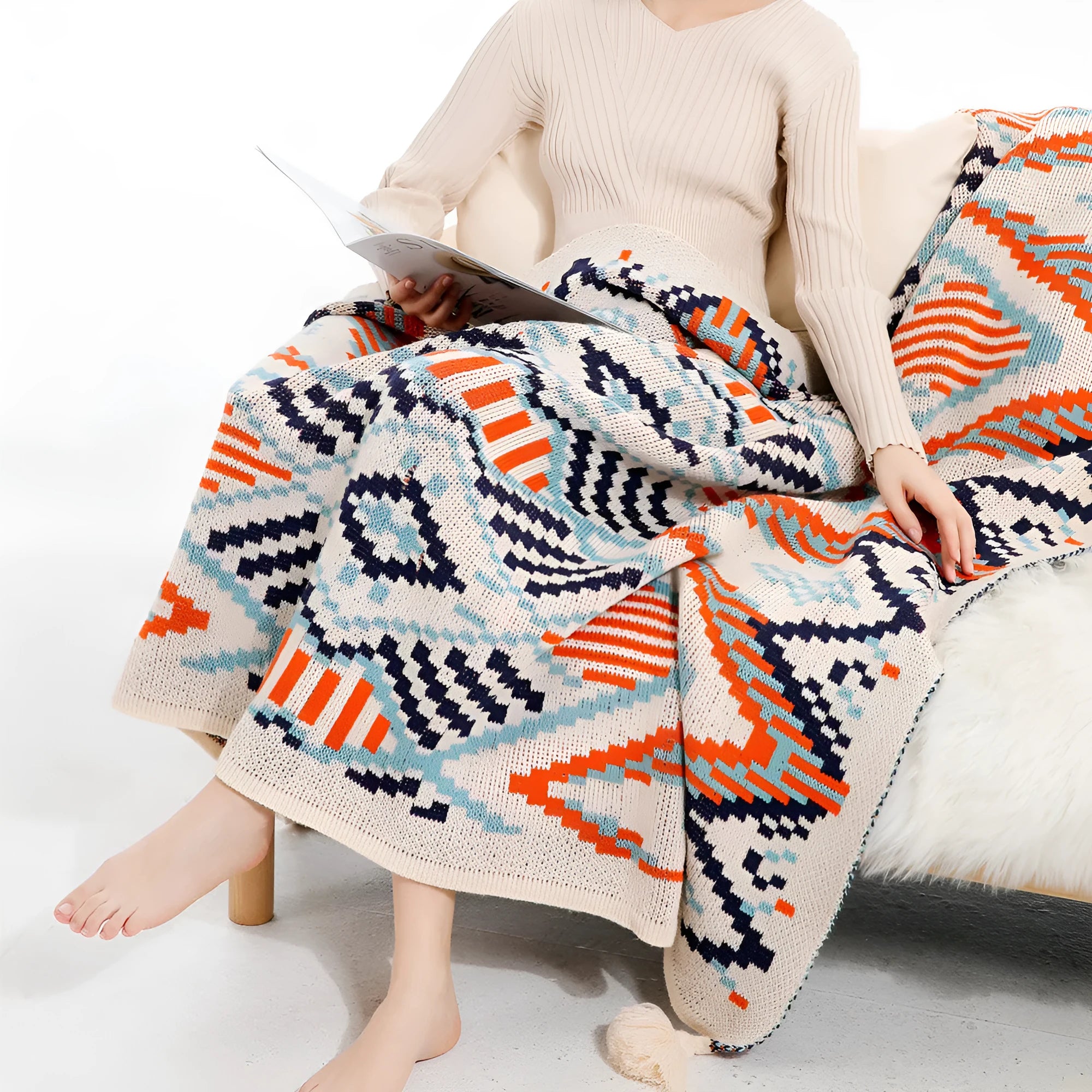 Acrylic sofa cover blanket with tassel trim in beige and orange colour.