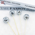 Glass mirror ball cake decoration on a wooden stick, available in four different sizes.