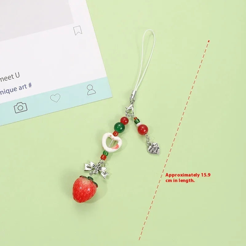 Coloured plastic fruit phone charms with rope attachments including apple and strawberry designs
