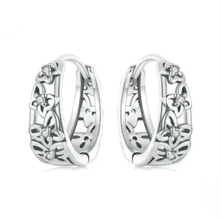 Sterling silver retro hollow butterfly earrings with zircon accents on a white background.
