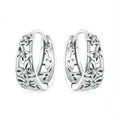 Sterling silver retro hollow butterfly earrings with zircon accents on a white background.