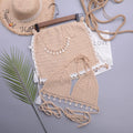 Women's black handmade shell design swimsuit with lace-up front detail on a mannequin.