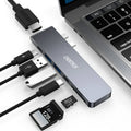 Silver USB-C to multi-port adapter hub with SD card slot, HDMI, USB ports, and PD charging