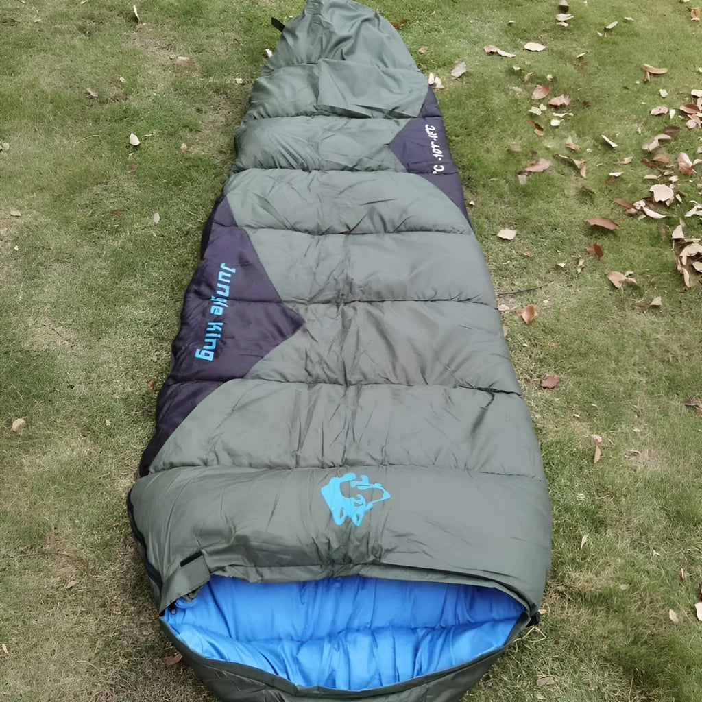 Cotton sleeping bag in Army Green colour with its compression sack, sized for outdoor camping.