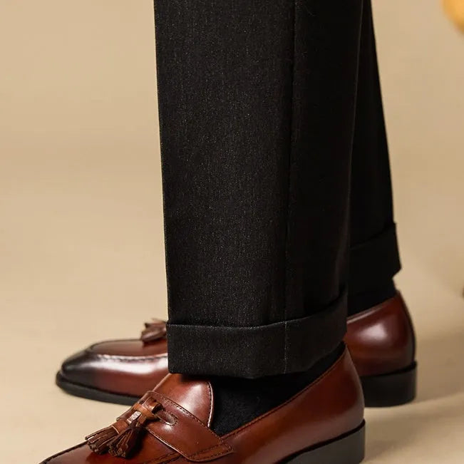 Men's genuine leather tassel loafers in black and brown colours showing polished uppers and rubber soles