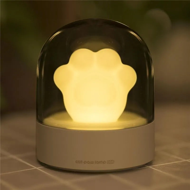 Cat paw-shaped night light with music box function showing pink colour option with illuminated soft light