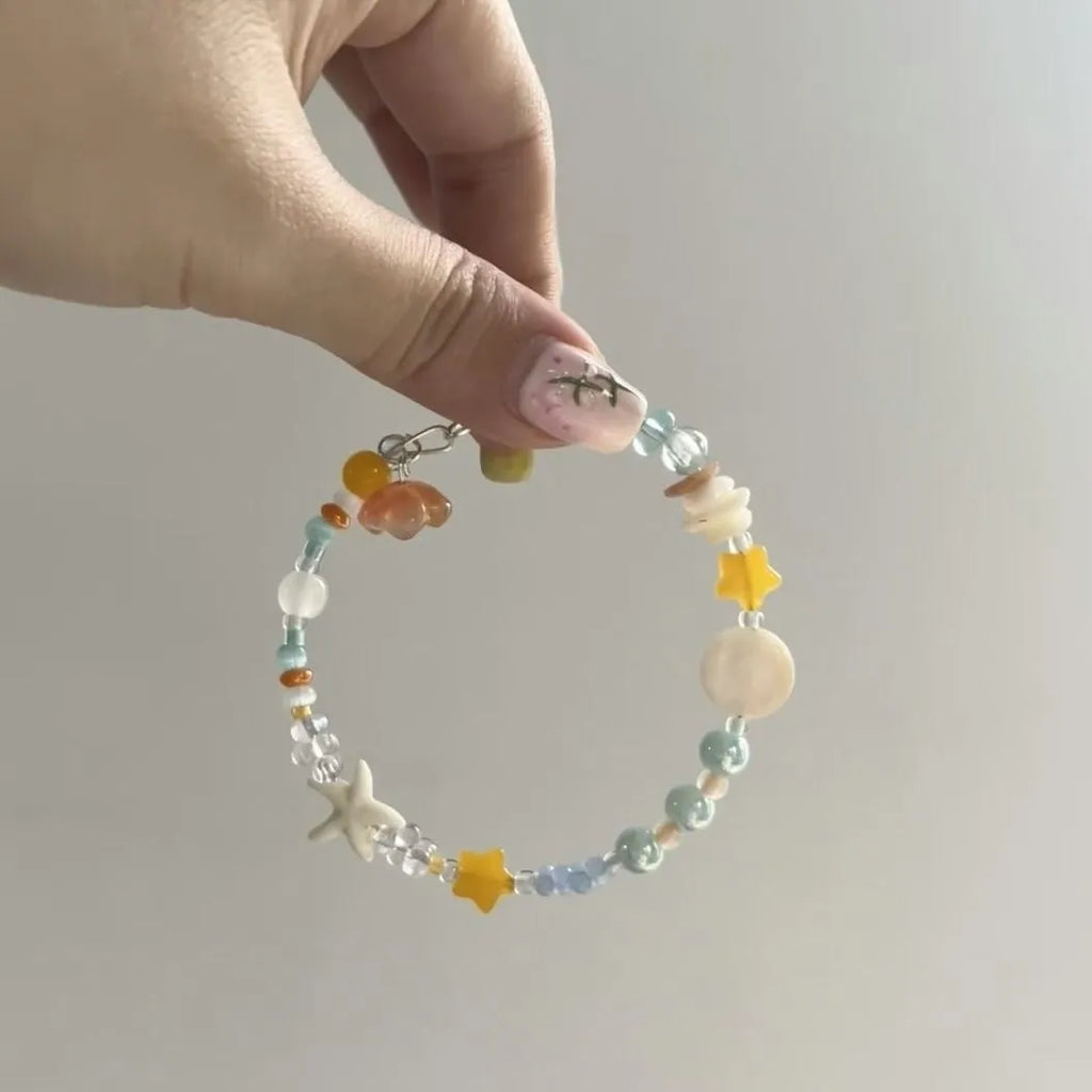 Orange alloy bracelet for women with a diamond shape and round decorative elements on a summer seaside theme.