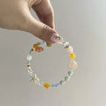 Orange alloy bracelet for women with a diamond shape and round decorative elements on a summer seaside theme.