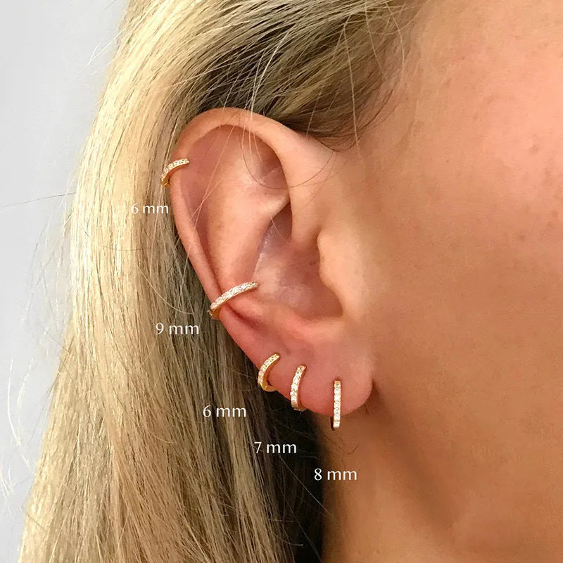 Gold, rose gold, and silver circle stud earrings with a perforated geometric design in various sizes.