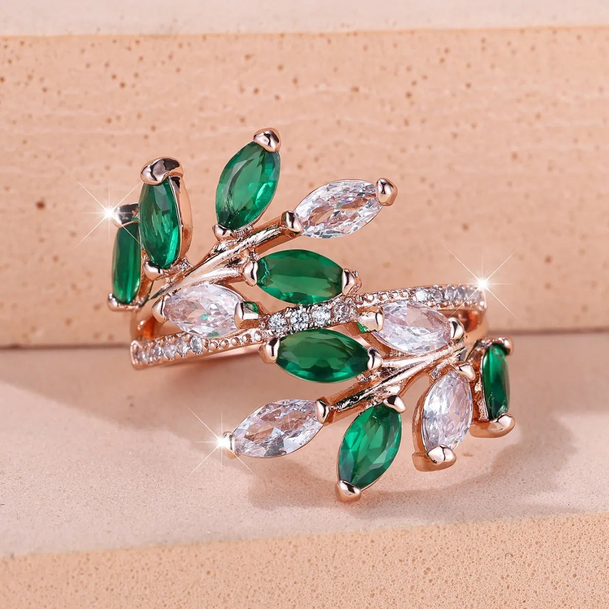 Adjustable copper leaf-shaped ring with zircon gemstone colour options on a white background.