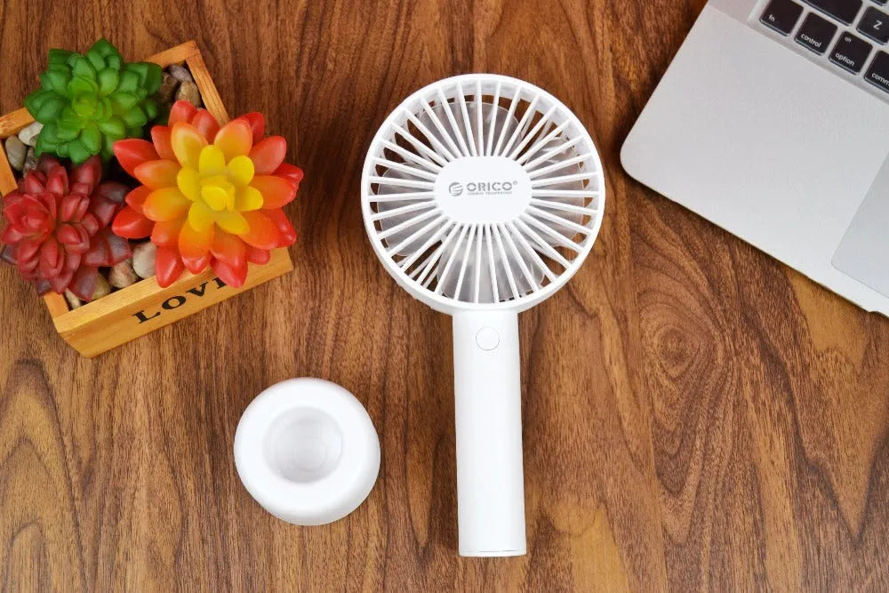White ORICO FH1 portable USB rechargeable fan with three-speed control on desktop