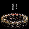 Natural citrine scattered bead ball bracelet showing 7A and 6A colour grades on a model's wrist.