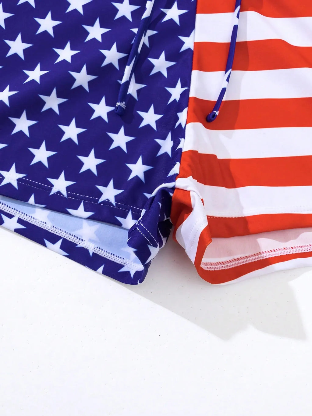 Women's high waist boxer style swimsuit with drawstring in red, white, and blue Stars and Stripes pattern.