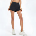 Women's black high waist nylon fitness shorts for running and gym workouts.