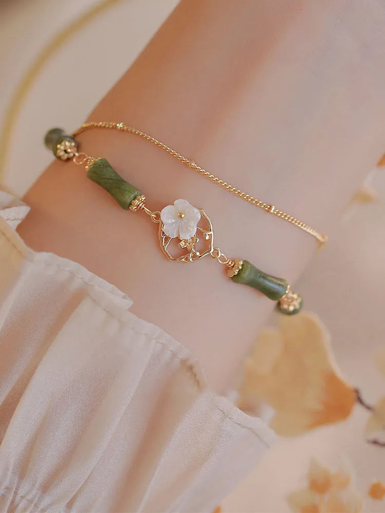 Handmade natural olivine women's bracelet with Chinese double layer twin bells and an olive branch design.