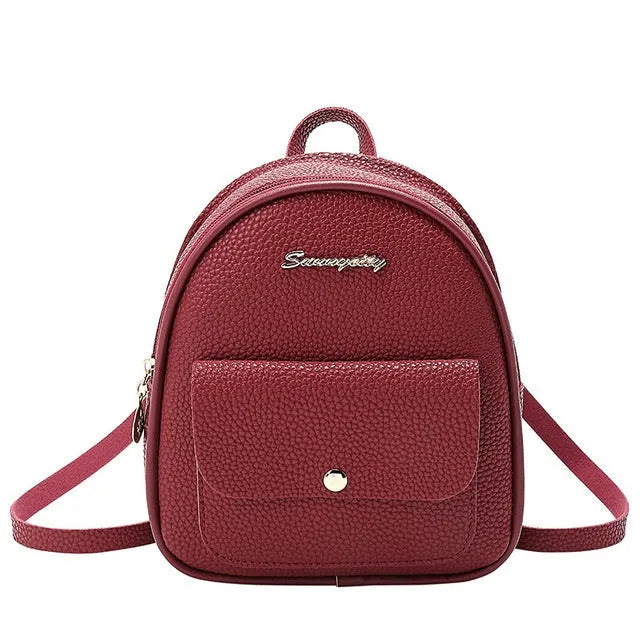 Small black PU women's backpack with shoulder strap showing compact dimensions