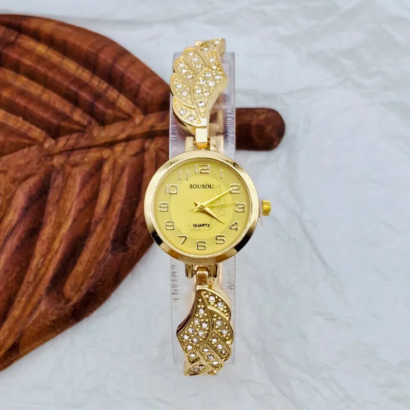 Women's stainless steel watch with round dial in gold, black gold, or white gold finish.