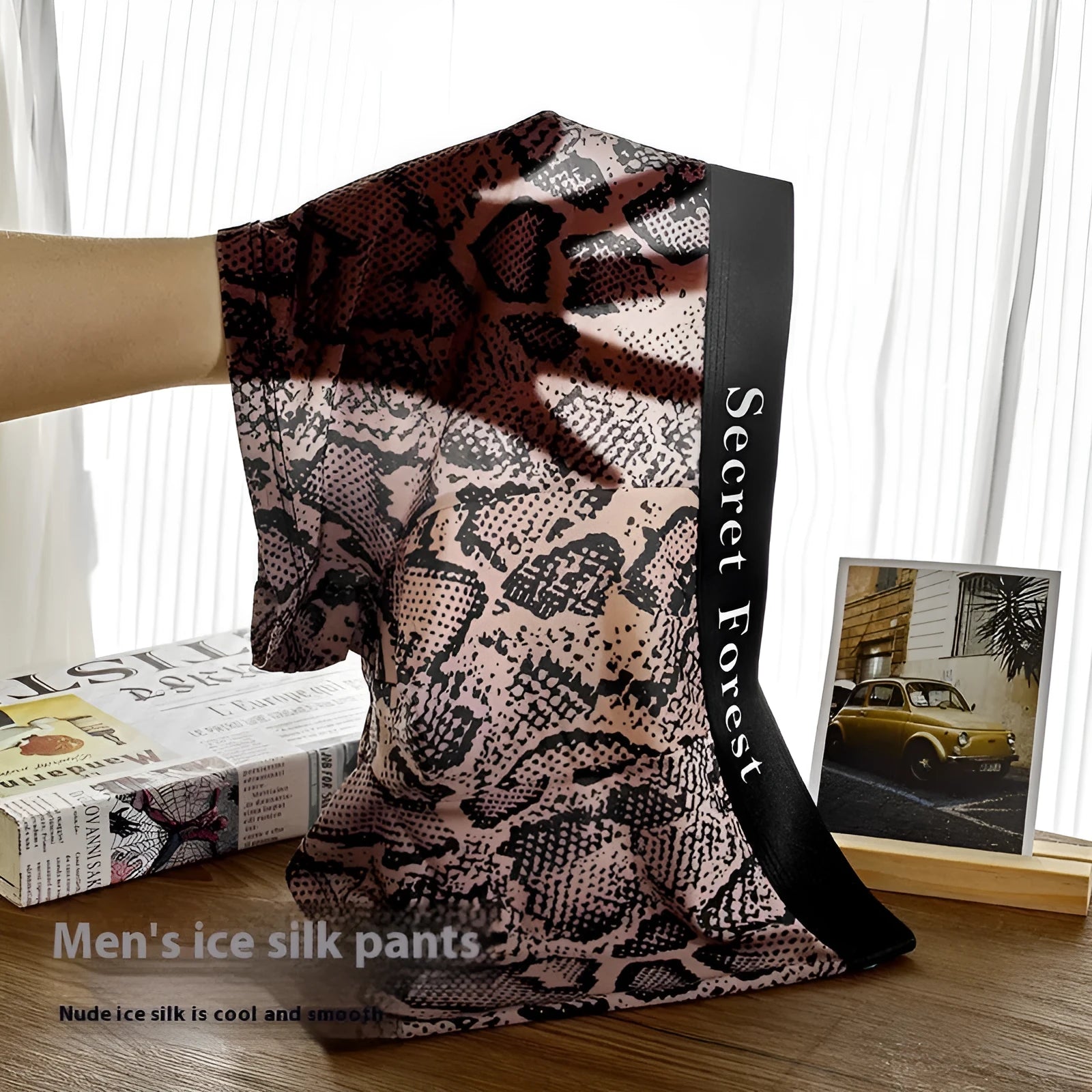 Men's black loose fit thin polyester boxer shorts on a mid waist