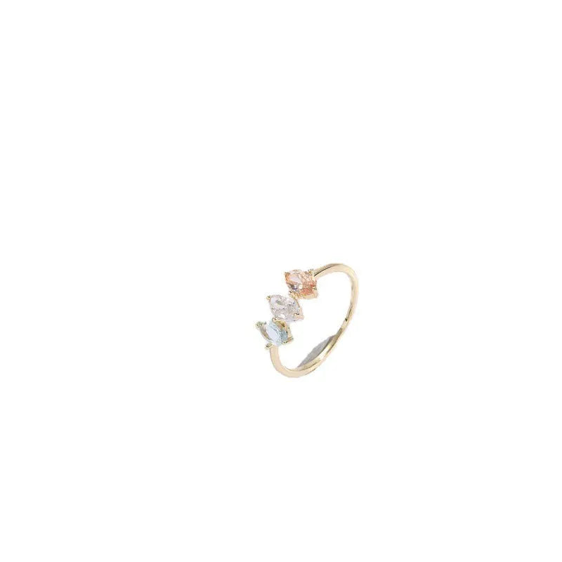 Geometric triangle birthstone ring with tricolour zircon and horse eye motif in gold plating.