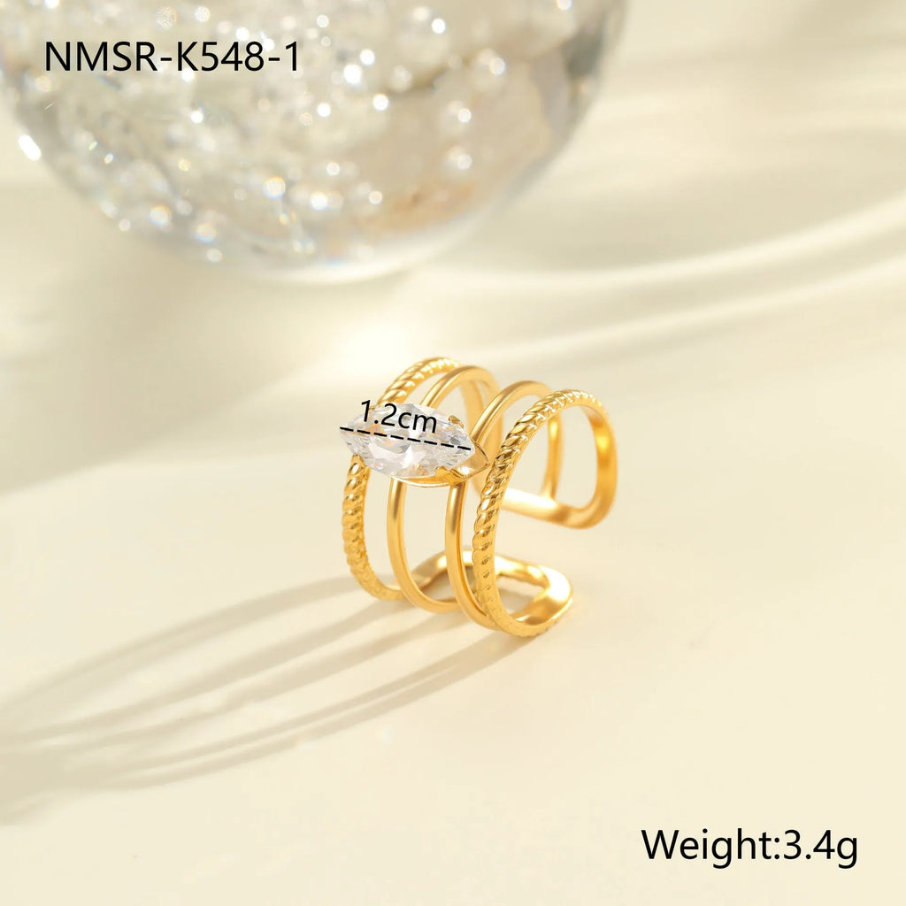 Gold-coloured stainless steel ring with an inlaid zircon stone and geometric heart design on an adjustable open mouth band.