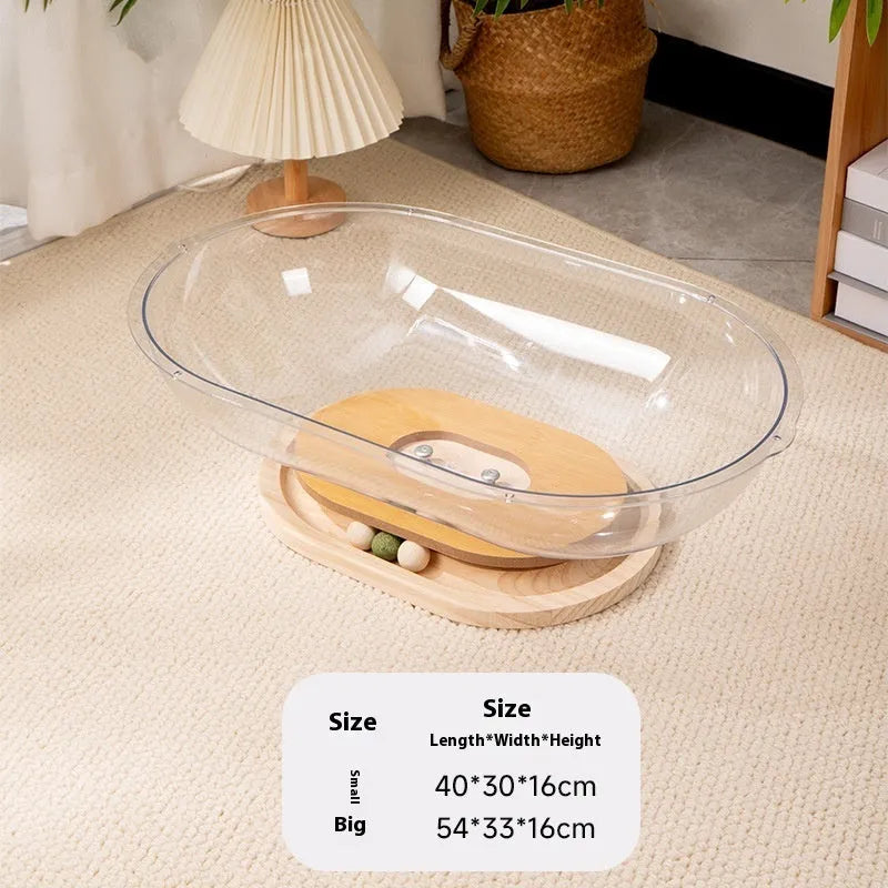 Transparent acrylic cat space capsule bathtub bed or cage on a wooden floor.