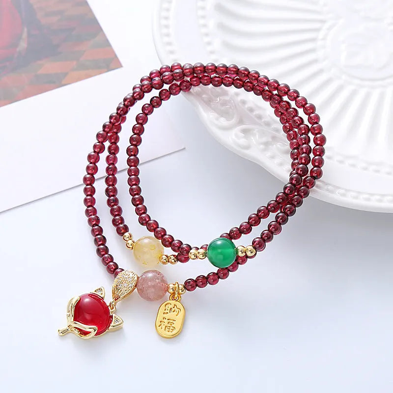 Purplish red garnet fox bracelet with adjustable rope closure and nature-inspired charm