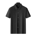 Man wearing a plus size loose fit black striped cardigan shirt with a square collar.