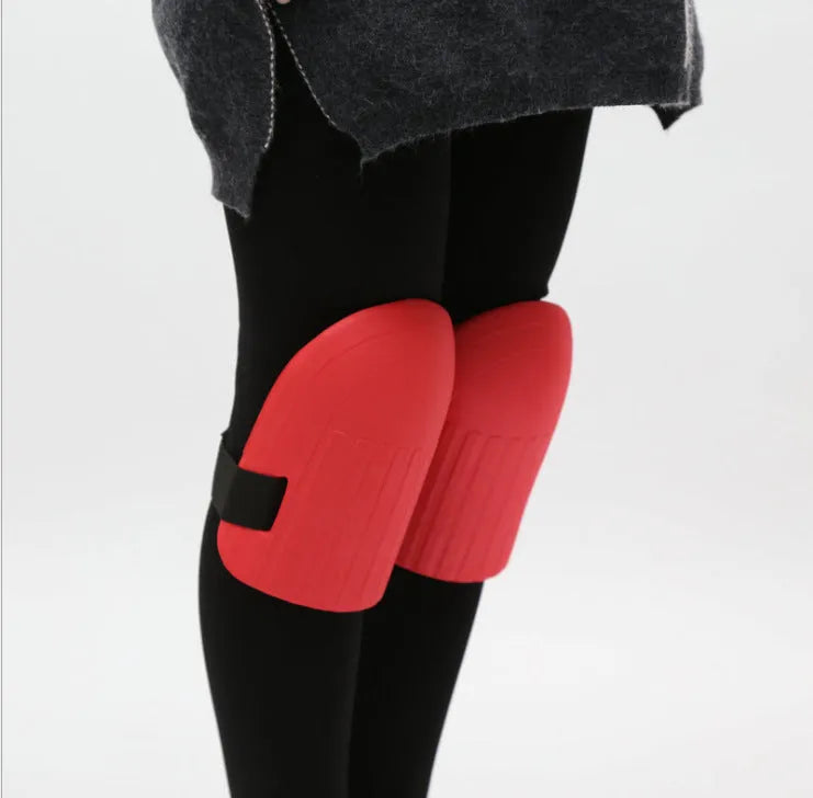 A pair of black EVA foam knee pads for gardening, showing their rectangular shape and soft texture.