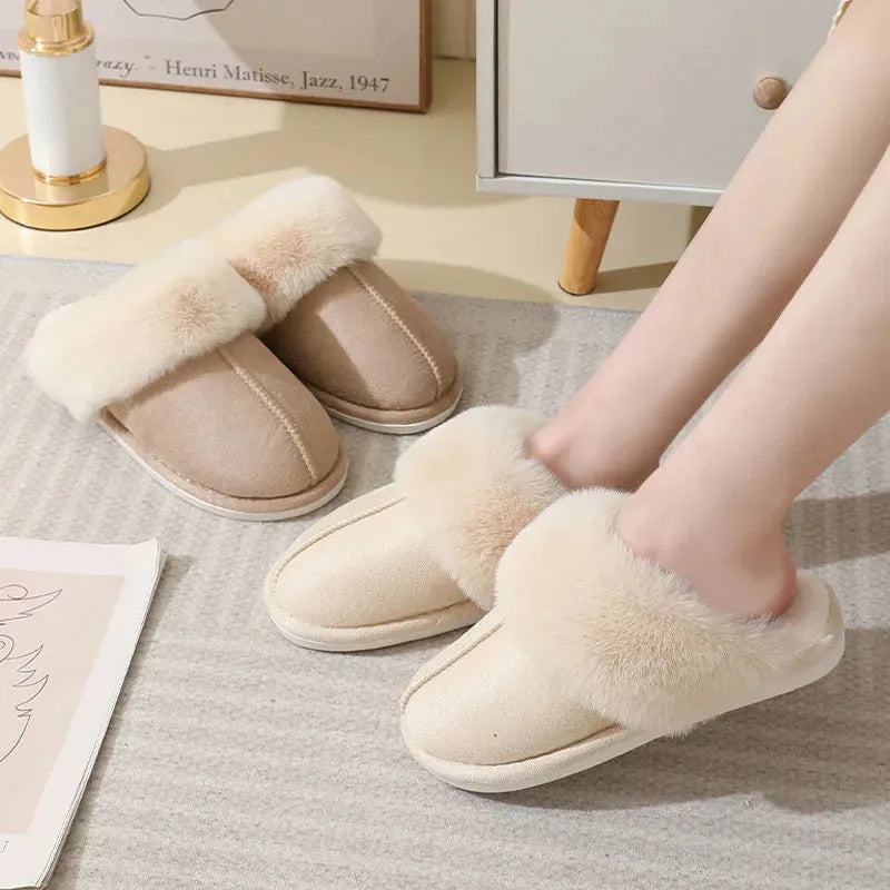 A pair of round-toe flat-heel plush slippers with stitching detail, shown in one of five available colours.