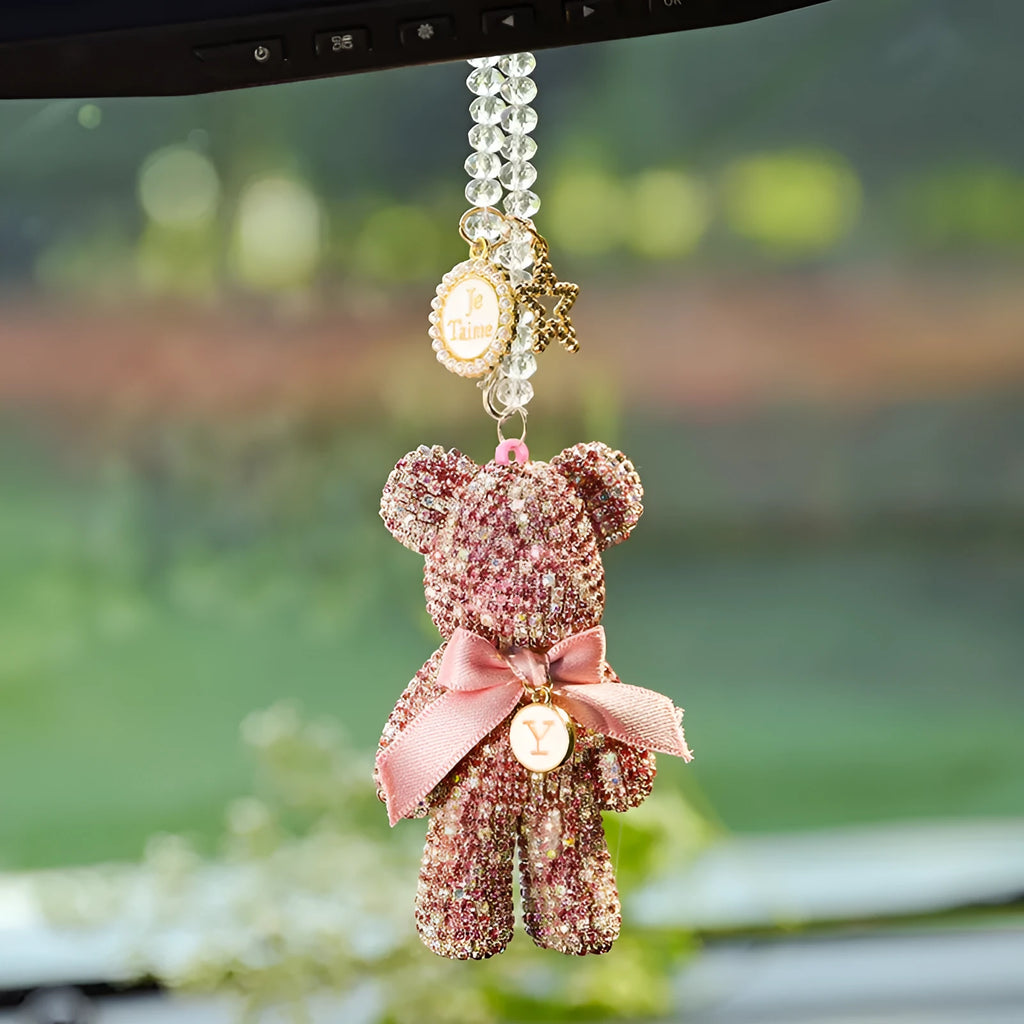 Close-up of a black Violent Bear-shaped car pendant with sparkling rhinestones, hanging from a rearview mirror.