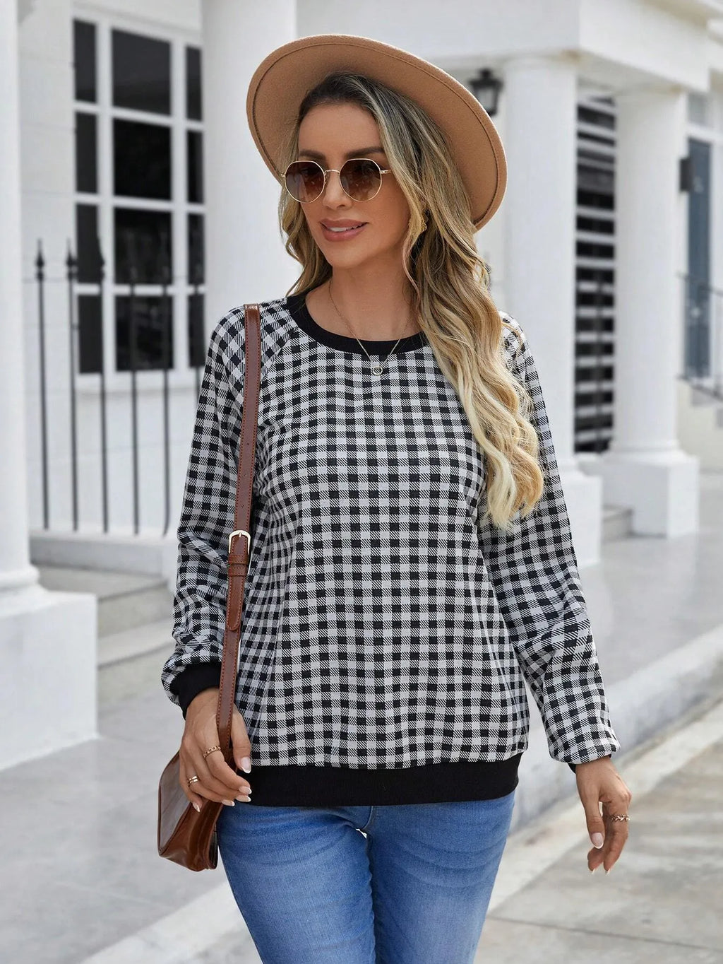 Black long sleeve plaid pullover sweater with Japanese style printing laid flat.
