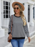 Black long sleeve plaid pullover sweater with Japanese style printing laid flat.
