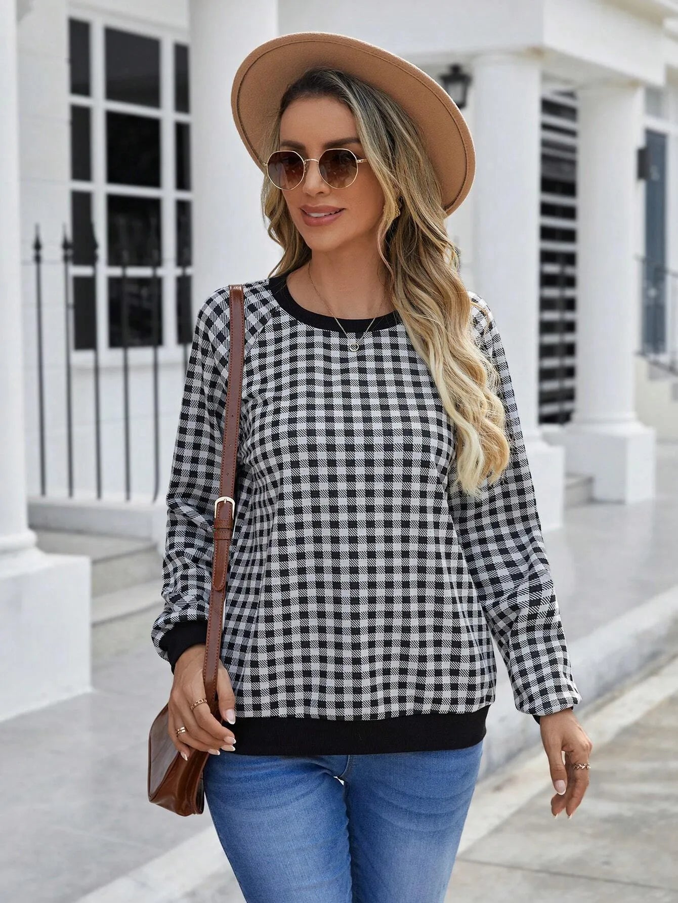 Black long sleeve plaid pullover sweater with Japanese style printing laid flat.