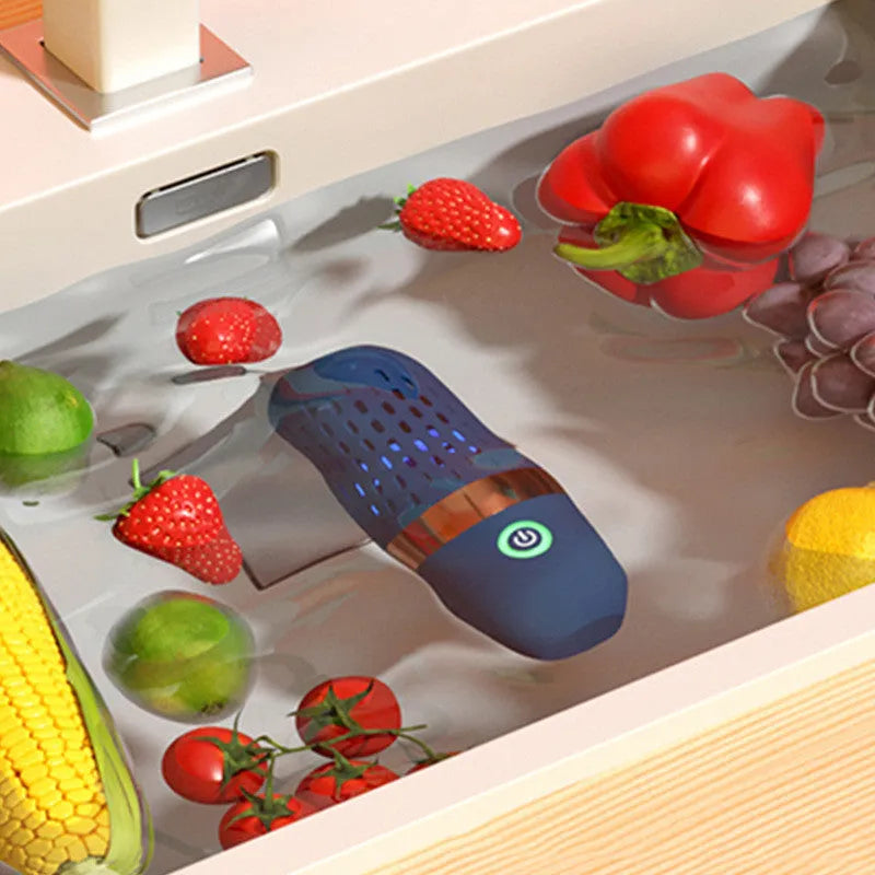Blue capsule fruit and vegetable cleaner on a kitchen surface with USB charger