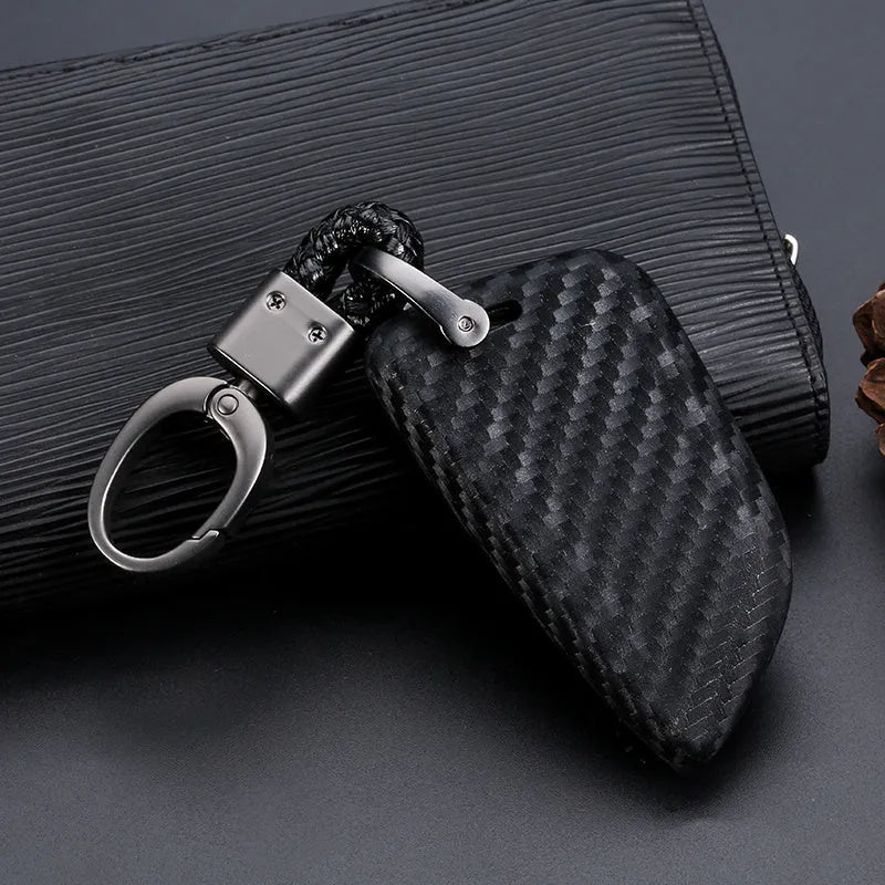 Carbon fibre silicone key case cover for blade-style car keys with impact cushioning and precise button cutouts