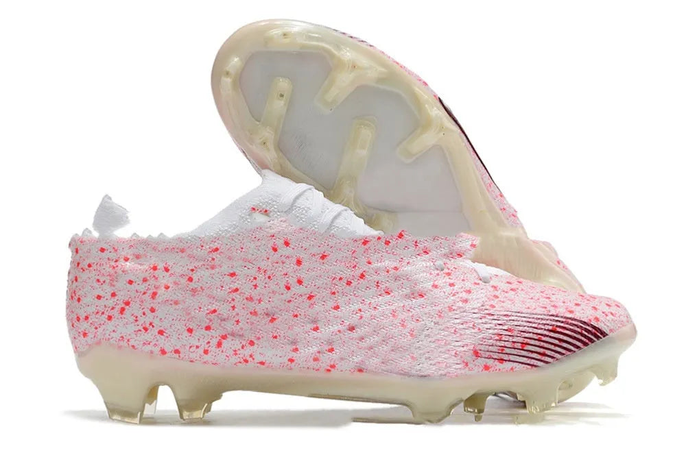 Men's low-top football shoes with knitted waterproof upper, lace-up front, and rubber FG studded sole