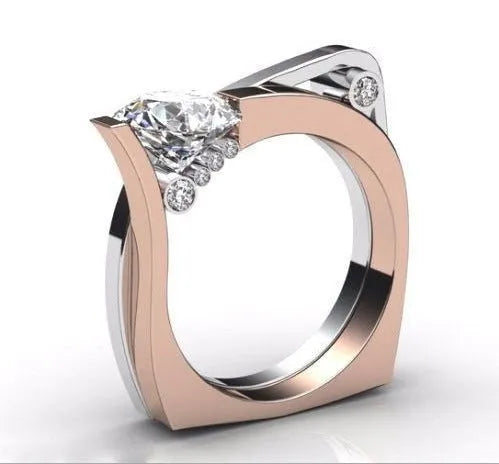 Women's geometric couple ring with inlaid zircon stone in electroplated rose gold on a grey background.