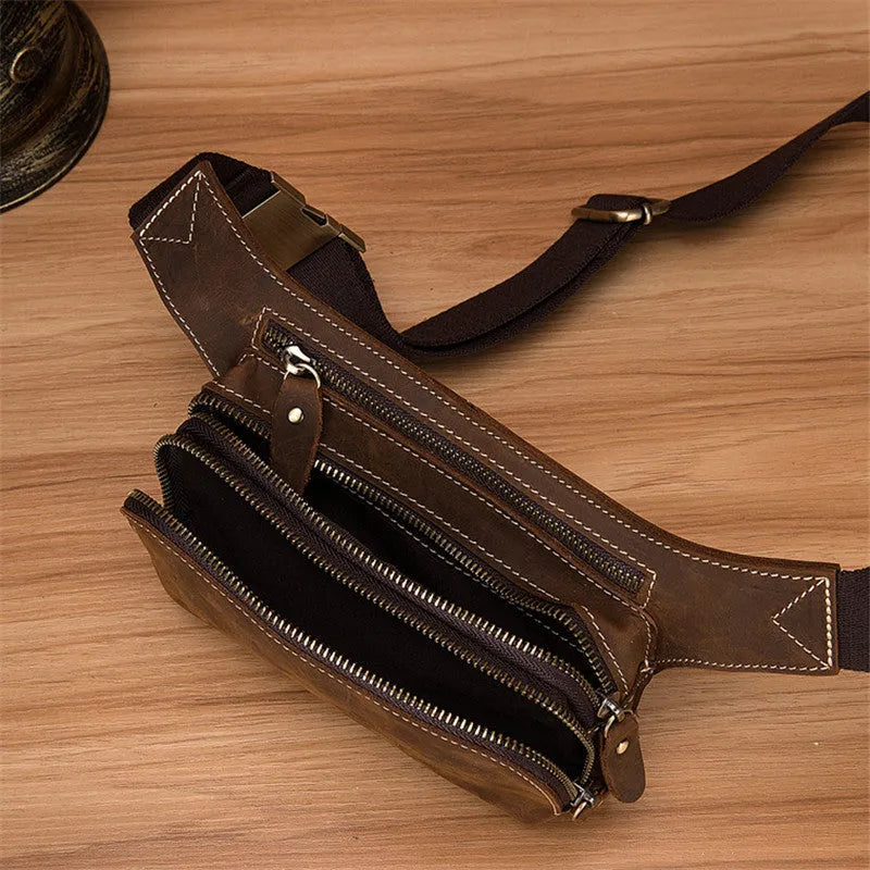 Brown cowhide men's sports waist bag with pull closure showing internal phone compartment
