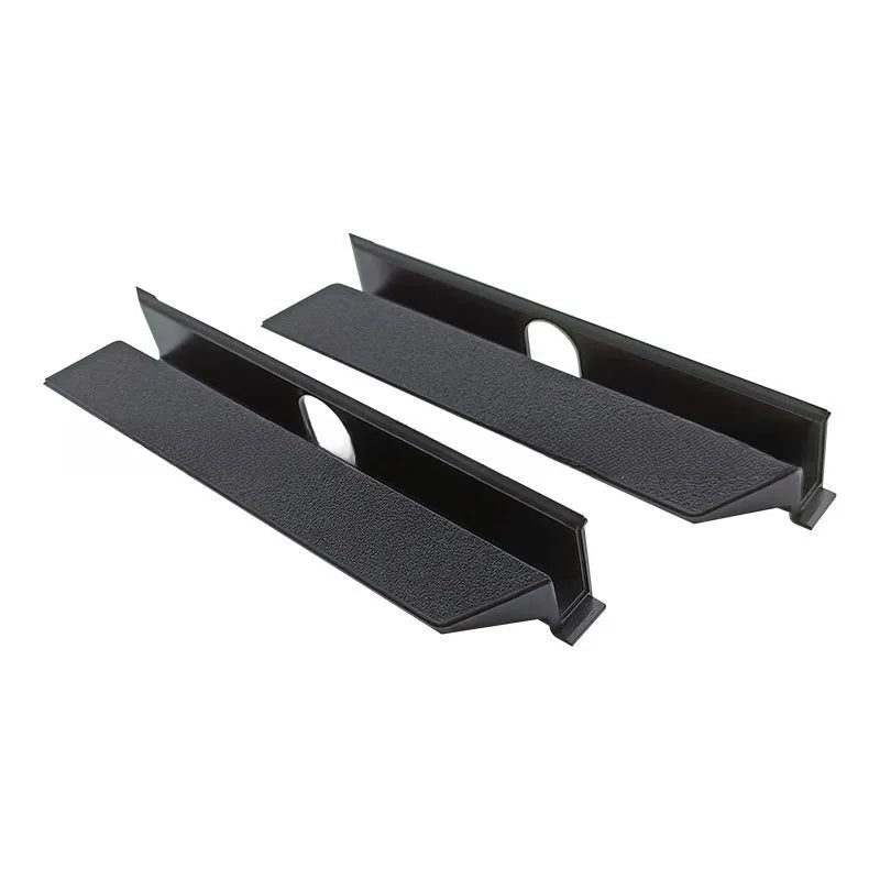 Black PS4 Pro hard drive bottom cover and small plastic repair parts including a baffle and strip.
