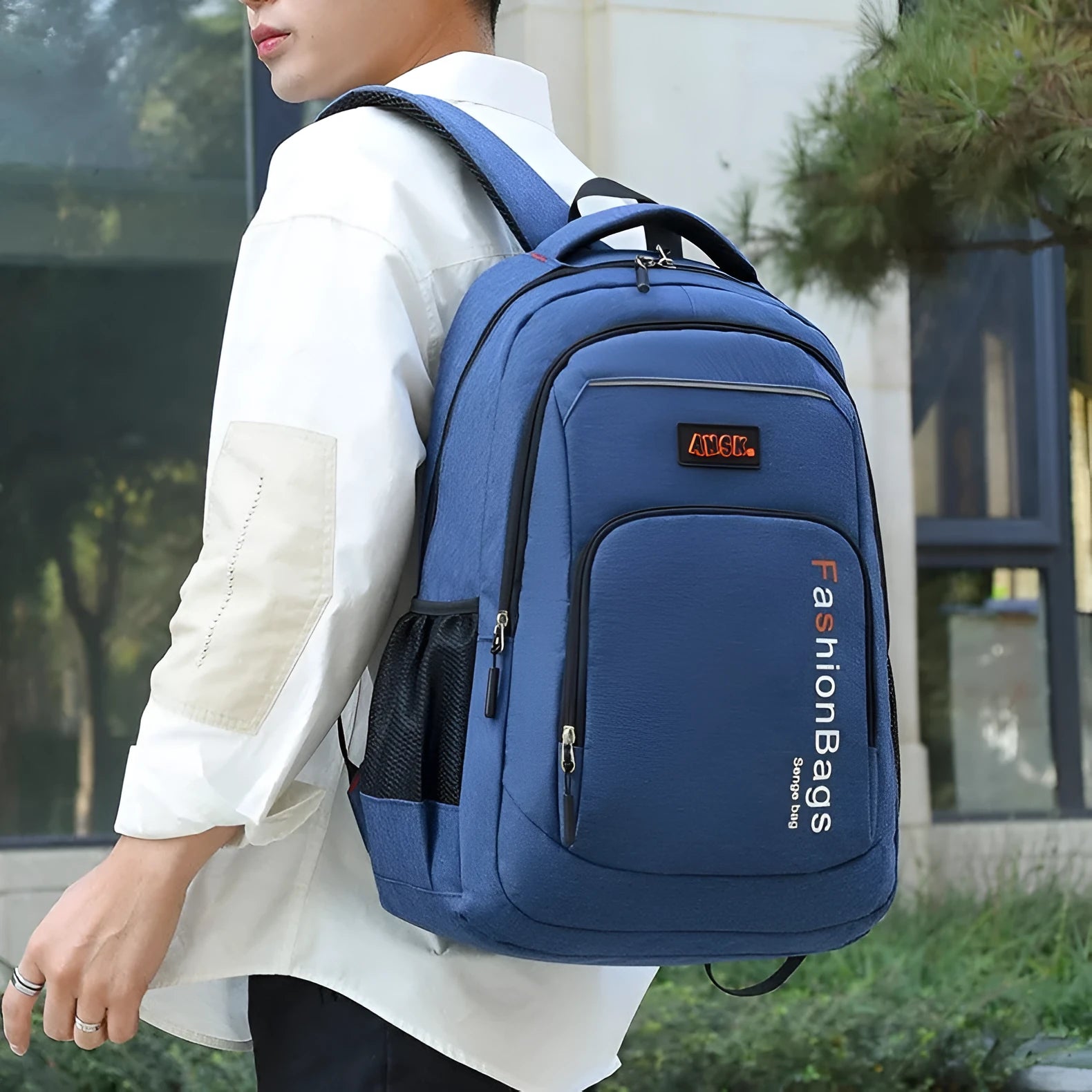 Black nylon backpack with multiple zippers and double shoulder straps shown open to reveal internal laptop and organisation compartments.