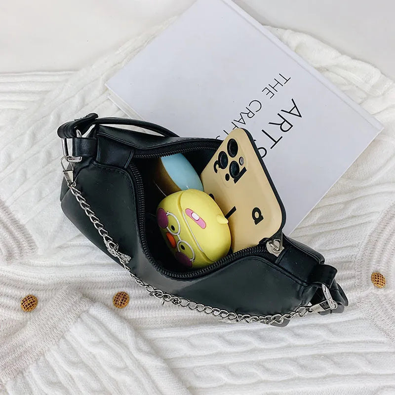 Women's butterfly chain underarm bag in black colour showing crossbody strap and three-dimensional pocket